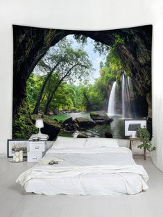 a bed room with a large wall hanging above it and a waterfall in the background