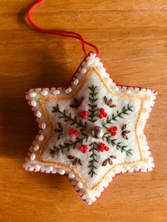 a christmas ornament hanging on a wooden table