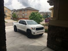 a white truck parked in front of a house