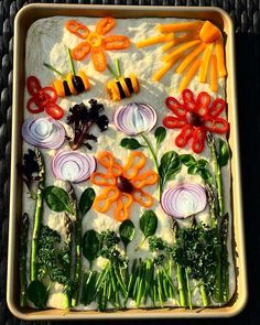 an assortment of vegetables laid out in a baking pan