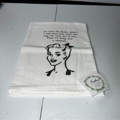 a white tea towel with a black and white drawing of a woman's face on it