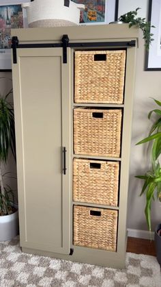 an armoire with three wicker baskets on it