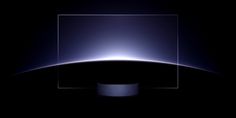 an apple desktop computer screen with the light reflecting off it's back end and side