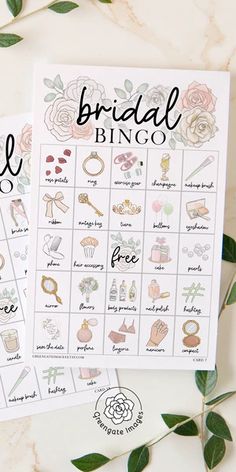 the bridal bingo game is shown with flowers and greenery around it on a marble surface