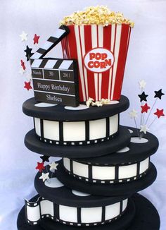 a three tiered cake decorated with popcorn and stars