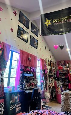 a room filled with lots of pink and black decorations on the wall next to windows