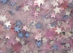 the stars are all over the ground in pink, blue and white colors with glitter on them