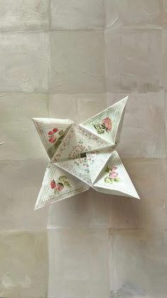 an origami star with pink flowers on it