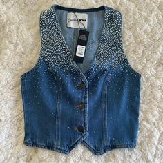 Available In Medium Wash. Denim Vest Embellished Faux Pockets Button Closure Disclaimer: Due To The Specialized Wash Process, Each Garment Is Unique. 100% Cotton Bedazzled Denim, Denim Vest Top, Denim And Pearls, Stage Ideas, Fashion Nova Bodysuit, Linen Crop Top, Pink Vest, Girls Crop Tops, Jean Vest