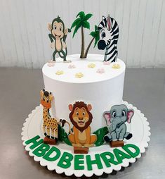 a white cake with animals and letters on it