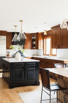 a kitchen with wooden cabinets and an island