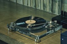 a record player sitting on top of a wooden table