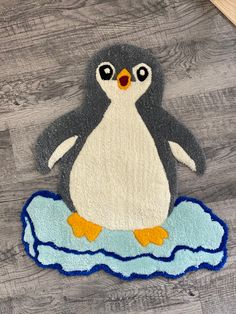 a penguin rug sitting on top of a wooden floor