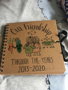 a notebook with an image of two people and the words, our friends through the years 2013 - 2020