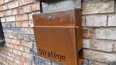 an old brick building with a sign on the side that says stratege next to it