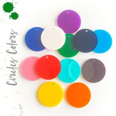 there are many different colored discs on the white background with green and blue ink in it