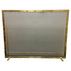 a metal frame with rivets on the sides and a white backdrop behind it