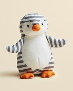 a stuffed penguin is wearing a striped shirt