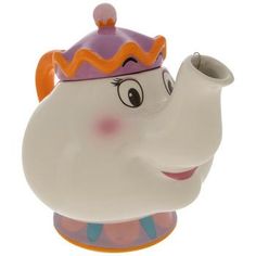 a teapot shaped like an elephant with a purple hat on it's head