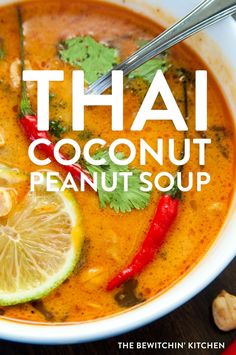 thai coconut peanut soup in a white bowl with limes and red peppers on the side