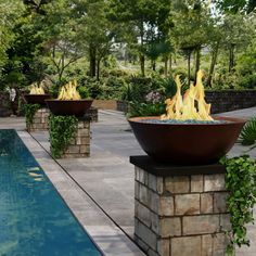 an outdoor fire pit next to a swimming pool