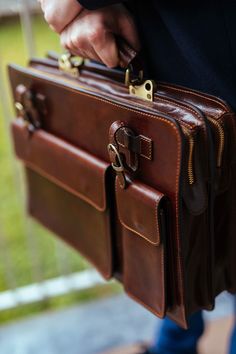 Our company's artisans combine old world craft methods with modern function, thus creating a non-bulky European design that's perfect for today's professional on the go. The rich character of these luxury products will age beautifully and develop into a better version than when first purchased. Briefcases for men are more than an accessory. A leather briefcase bag is an extension of who you are and what you believe in. When we craft leather briefcase bags for men, they are designed to securely h Brown Vegetable Tanned Leather Briefcase With Waxed Finish, Brown Rectangular Briefcase For Daily Use, Brown Cases With Interior Card Slots For Daily Use, Brown Satchel Briefcase With Interior Card Slots, Office Leather Bag, Lawyer Bag, Brown Leather Laptop Bag, Mens Briefcase, Rich Character