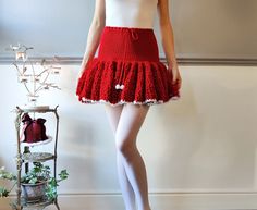 Part of my🎄 🎀 Christmas collection 🎀 🎄  MADE TO ORDER. Please allow up to 1 week for the skirt to be made. Knitted short skirt with crochet ruffle wave draping. Item details: Available sizes - XS S M L, UK 6 8 10 12 Model on the photos is wearing size M/10 178cm tall. Worn with white stockings.  Size M measurements: 75 -85cm around the waist, 40cm long.  Handmade by me from soft and chunky acrylic yarn in Coca-Cola red.  Very bouncy and thick material. Snow white edge and pompom ends on the Low Waisted Skirt, Knitted Skirt, Crochet Ruffle, White Stockings, Low Waisted, Christmas Collection, Christmas Knitting, Knit Shorts, Knit Skirt