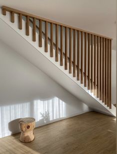 an empty room with wooden railings and a stool on the floor next to it