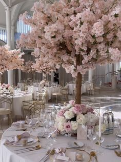 the tables are set with flowers and place settings for an elegant wedding reception at the grand america hotel