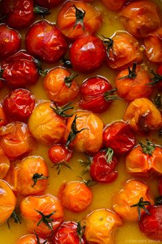 tomatoes are being cooked in a pan on the stove