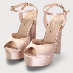 a pair of pink high heeled shoes with straps