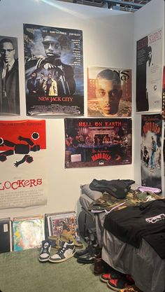 a room with posters on the wall and various items in it, including shoes and backpacks