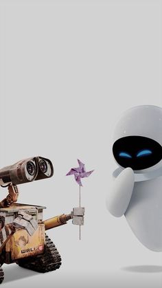 an image of a robot holding a flower and looking at another robot with eyes on it