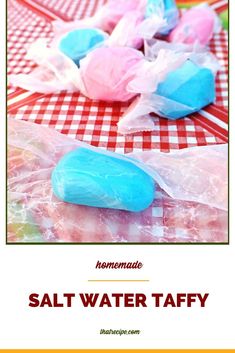 homemade salt water taffys are in plastic bags on a table with red and white checkered cloth