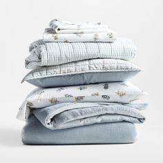 four folded sheets stacked on top of each other in different sizes and colors, all with the same pattern