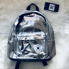 Converse Silver Metallic Mini Backpack New A Shiny Metallic Surface Styles A School-Gear Essential Backpack Built In A Classic Two-Compartment Design. Two-Way Zip Closure Top Carry Handle; Adjustable Shoulder Straps Exterior Zip Pocket Height 17 1/2” Width 11 1/2” Depth 5” Happy Poshing Silver Standard Backpack For Everyday Use, Trendy Silver Backpack For Travel, Silver Casual Backpack For Travel, Silver Standard Backpack For School, Silver Everyday Backpack, Silver Backpack For Back To School, Trendy Silver Backpack For School, Trendy Silver Backpack, Casual Silver Backpack For School