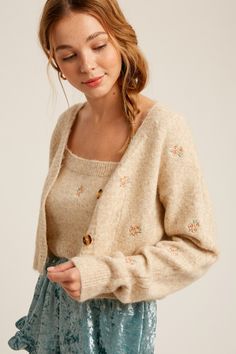 -Available in Sage & Oatmeal -Cami and cardigan sweater set -Cozy fur knit sweater -Flower embroidered -Crop length cami -Button down crop cardi -Content: 50% Nylon 25% Polyester 25% Acrylic -Imported -Model is 5' 10" 32-26-35 and wearing a size Small Flower Cardigan, Fairy Clothes, Black Femininity, Cropped Cardigan Sweater, Embroidered Cardigan, Floral Cardigan, Bodycon Fashion, Petite Outfits, Sweater Set