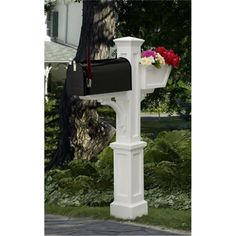 a white mailbox with flowers in it