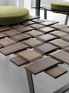 a wooden table with several pieces of wood on it and a green chair in the background