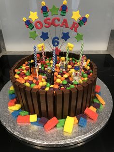 a birthday cake decorated with legos and candy