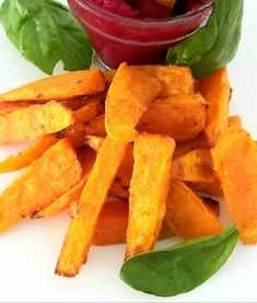 sweet potato fries with beet sauce and spinach leaves