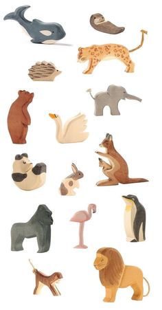 an assortment of wooden animals on a white background