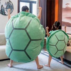 two people in turtle costumes standing next to each other