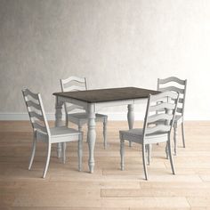 a dining room table with four chairs around it