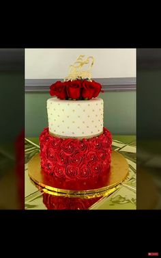 a three tiered cake with red roses on top