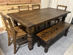 a wooden table with two benches next to it on a carpeted floor in front of a window