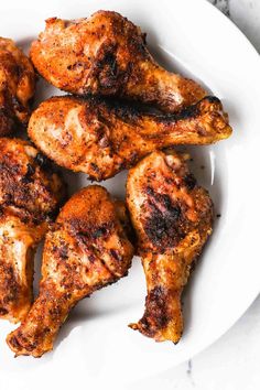 grilled chicken wings on a white plate, ready to be served in the oven