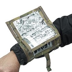 a hand holding an electronic device that is on top of the other hand, with pictures in it