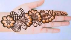 the hand is decorated with henna and flowers