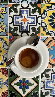 a cup of coffee sitting on top of a white saucer